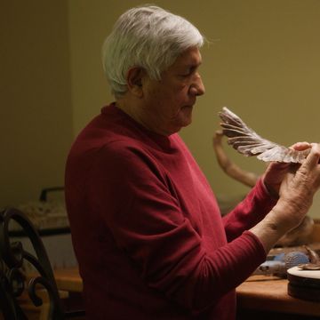 Michael Naranjo, U.S. Army veteran and sculptor, shaping a clay wing sculpture